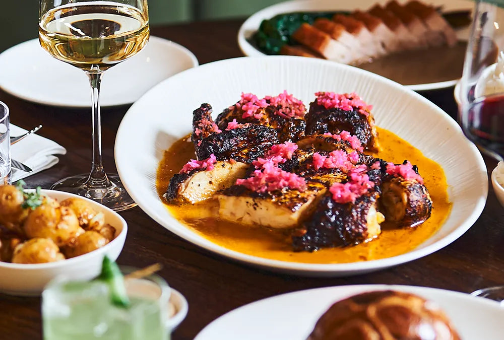 Selection of Filipino cooking on table with wine
