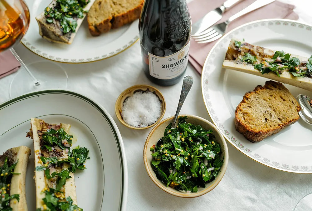 Dining table of cooked bone marrow and salad