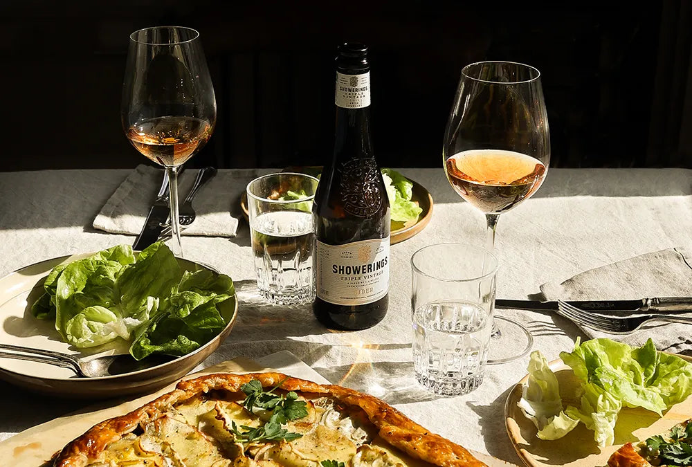 Dining table with cider, salad and galette